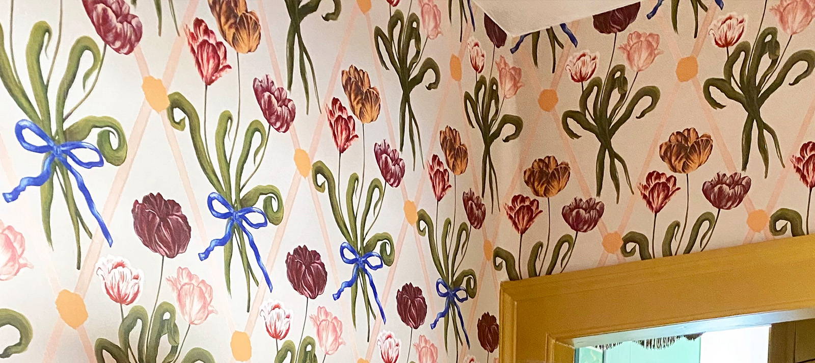 A close up of Polly Fern's wall paper featuring bows and flowers 