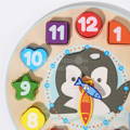 Wooden pieces of the Montessori Penguin's Clock children's toy with vibrant paint and numbers on them. 