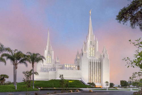 Picture of the San Diego Temple standing against a pink and blu sky.