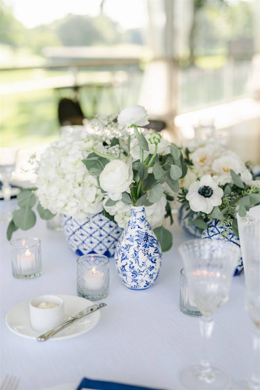 blue and white vases with white flowers centerpiece 