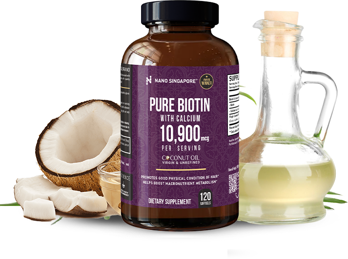 Bottle of NanoSingapore's best hair and skin supplements next to a coconut and bottle of oil