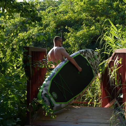 Boy lift lightweight stand up paddle board in Canada