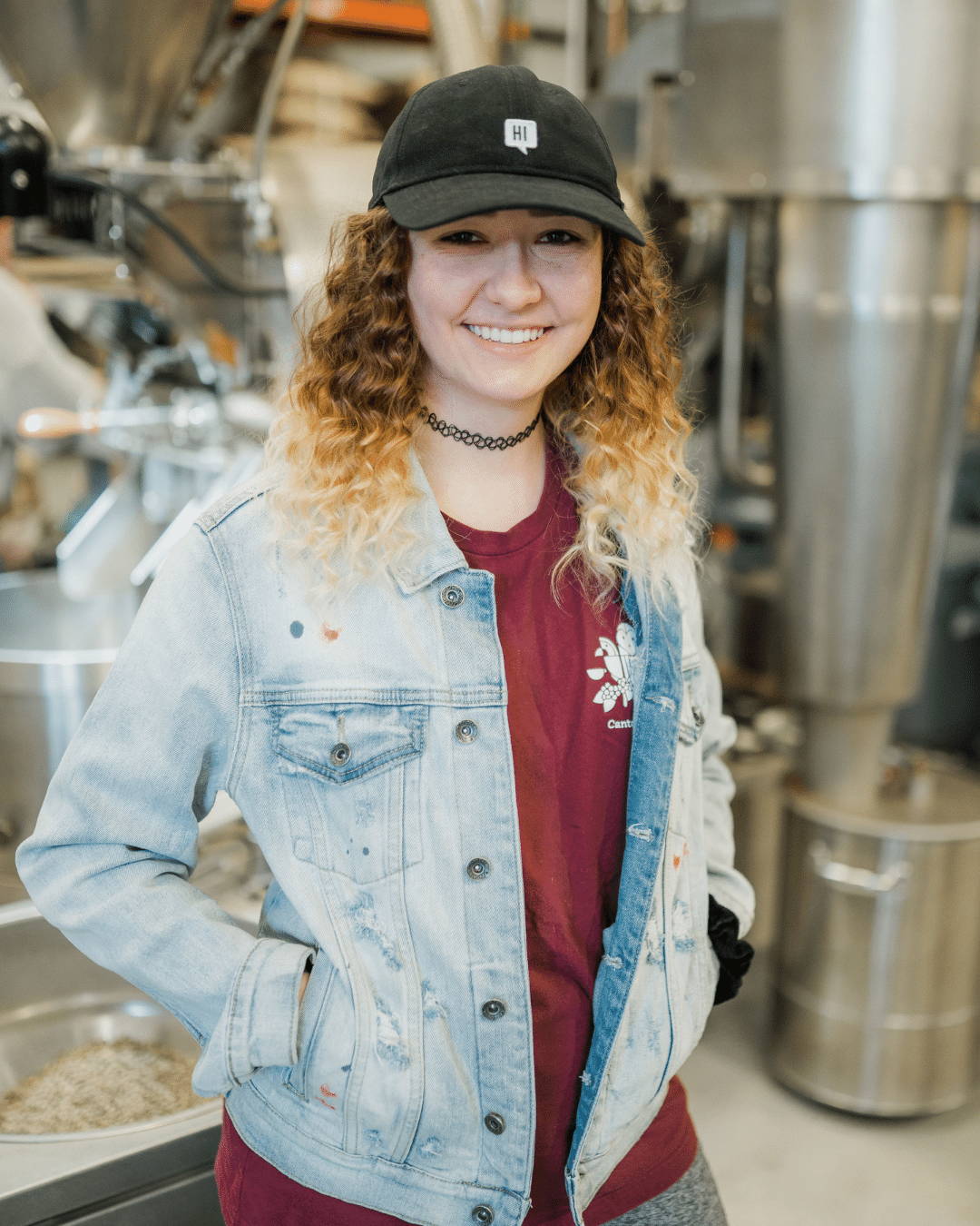 Woman standing beside coffee roaster