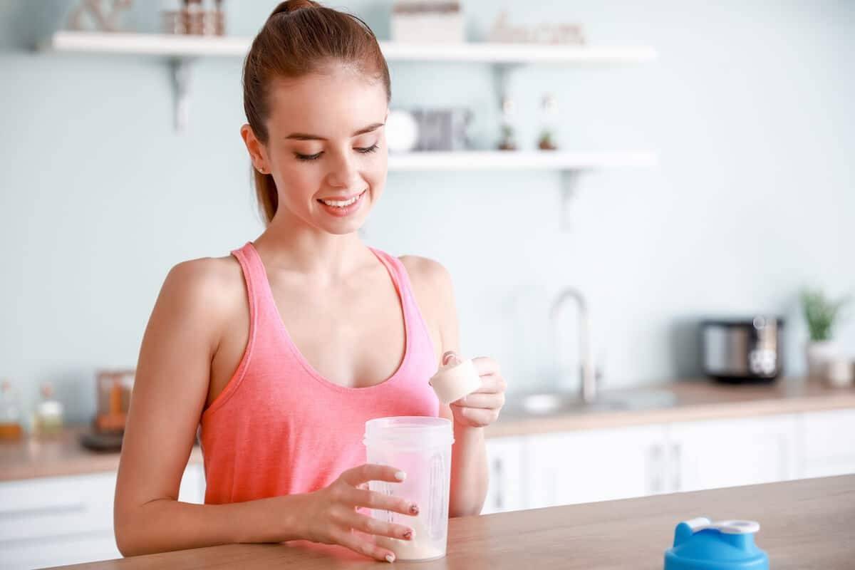 woman pouring protein