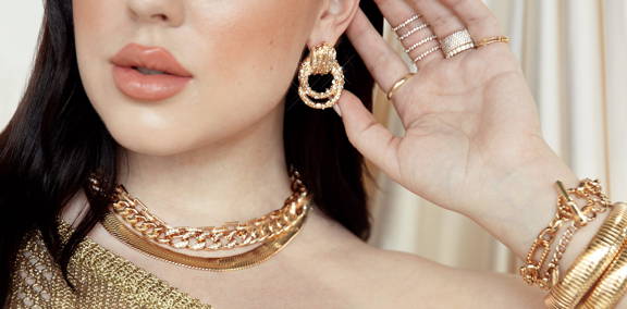 a model in 18k gold plated ettika jewelry