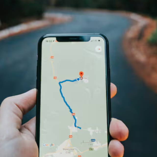 a person holding a smartphone with a map app open