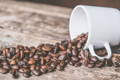 dark roasted beans stumbled out of a white cup