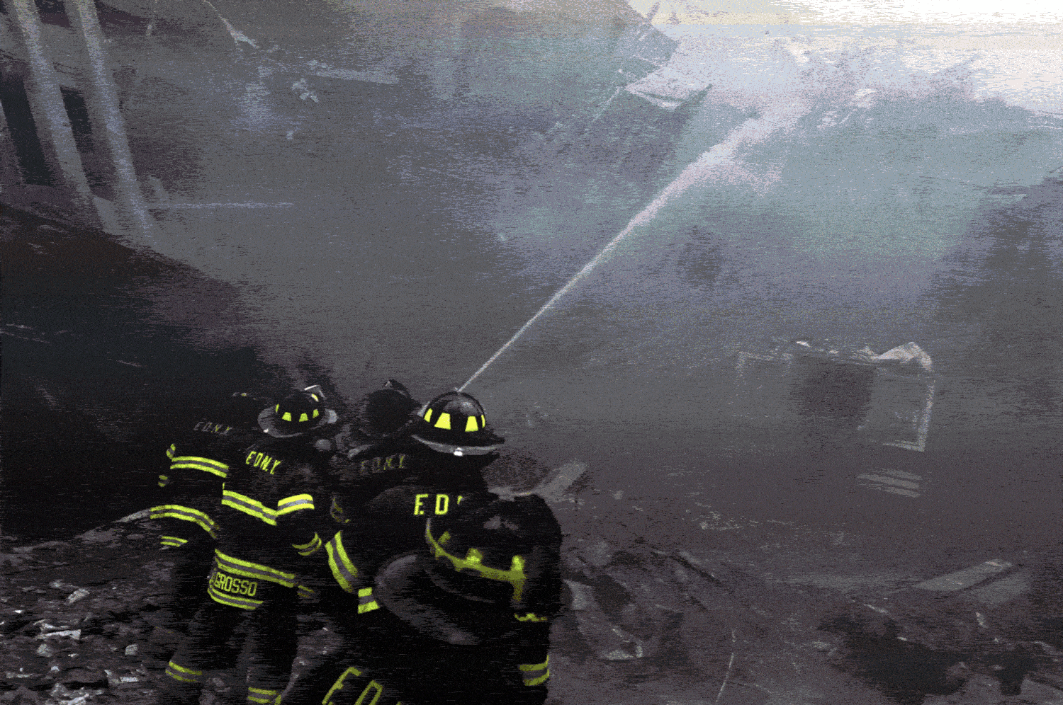 A gif of photographs of firefighters on 9/11 and people covering their faces from smoke.