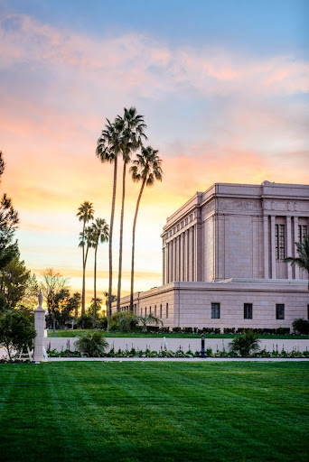 Side shot of the Mesa Temple. A sunrise is warming the horizon. 