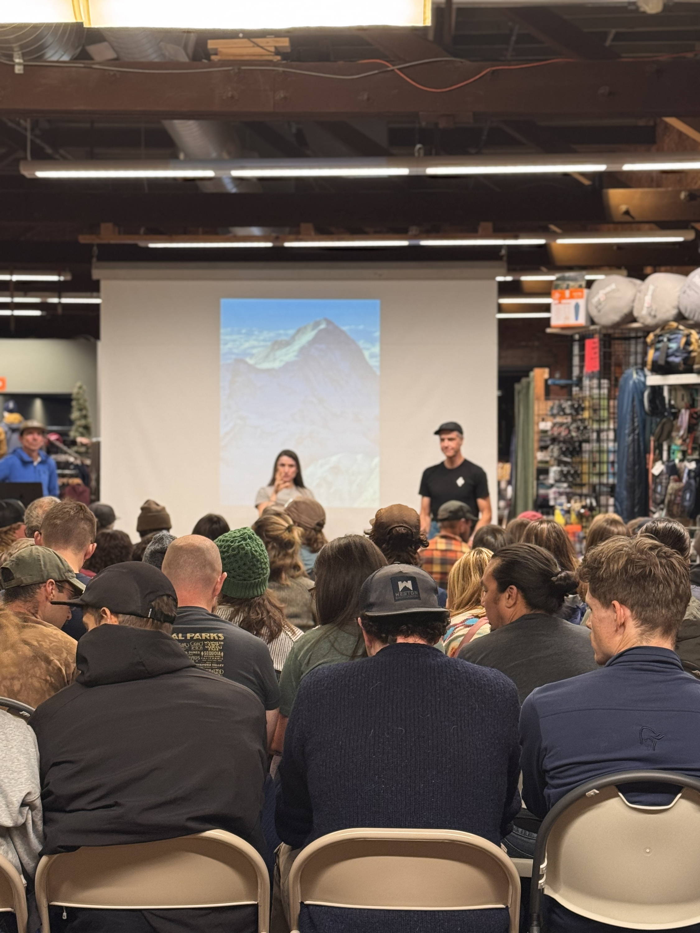 A large group gathers for an event at the shop.