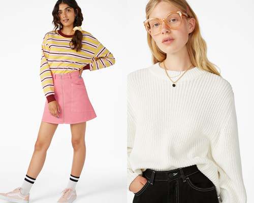 Woman wearing organic cotton t-shirt in burgundy, yellow and white with pink high waist zip up mini skirt and white tubular socks and light pink vans and woman wearing black jeans with a BCI cotton knitted oversized cream jumper, all from sustainable women's fashion brand Monki