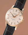grand Seiko watch with white dial, gold case on black strap - Everything you need to know about Grand Seiko