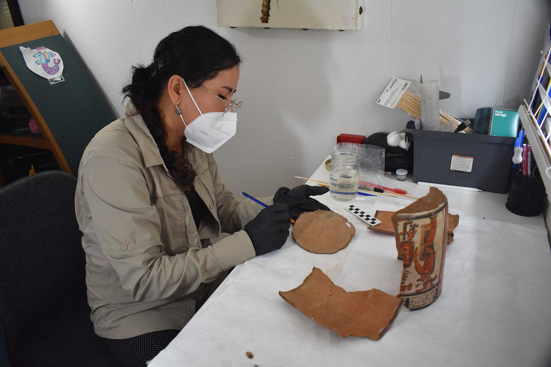 Conservator Perez working on a Maya object