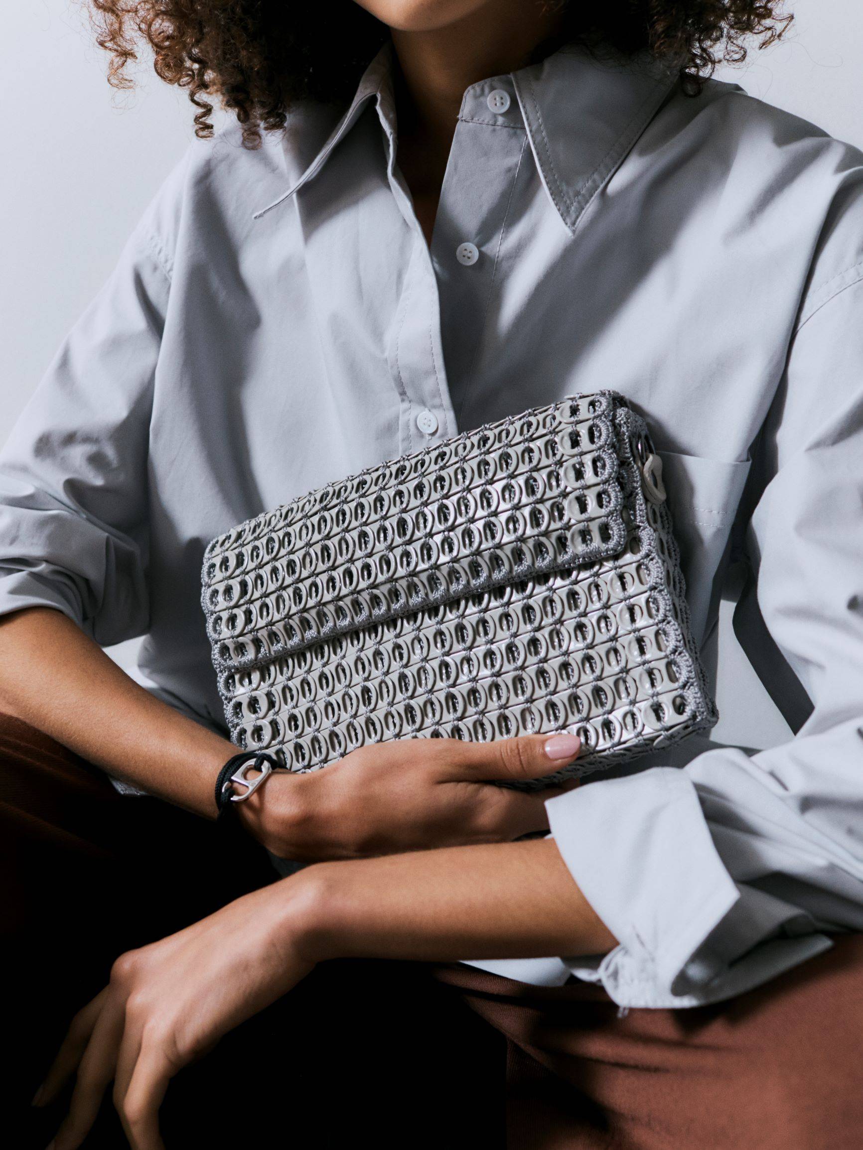 A BOTTLETOP bag made from recycled aluminium ring pulls