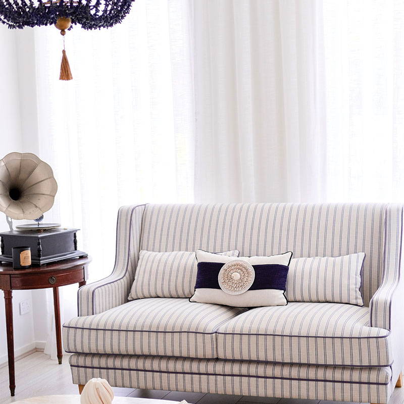 A Hampton cushion on a Hampton style sofa, featuring a coastal decor accessory