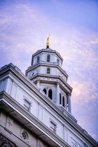 Nauvoo Temple Spire against a cloudy blue sky.