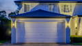 Outdoor wall lighting highlighting garage facade in Rouse Hill home by Havit