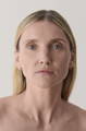 model with glowing, clear skin looking at the camera