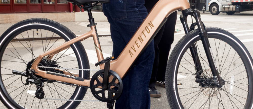 a gold aventon level electric city bike in chinatown