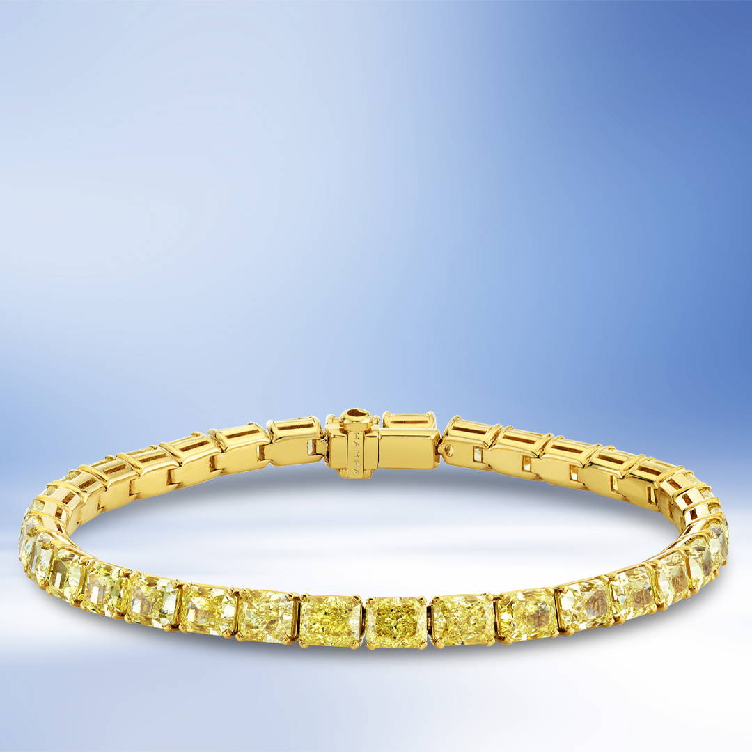 Radiant cut yellow diamond bracelet in yellow gold.