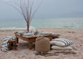 picnic setting on beach with tableware