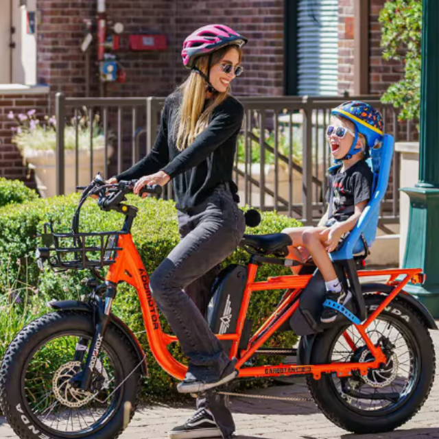 A lady on a cargo bike with a child