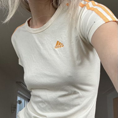 cream adidas shirt with orange stripes