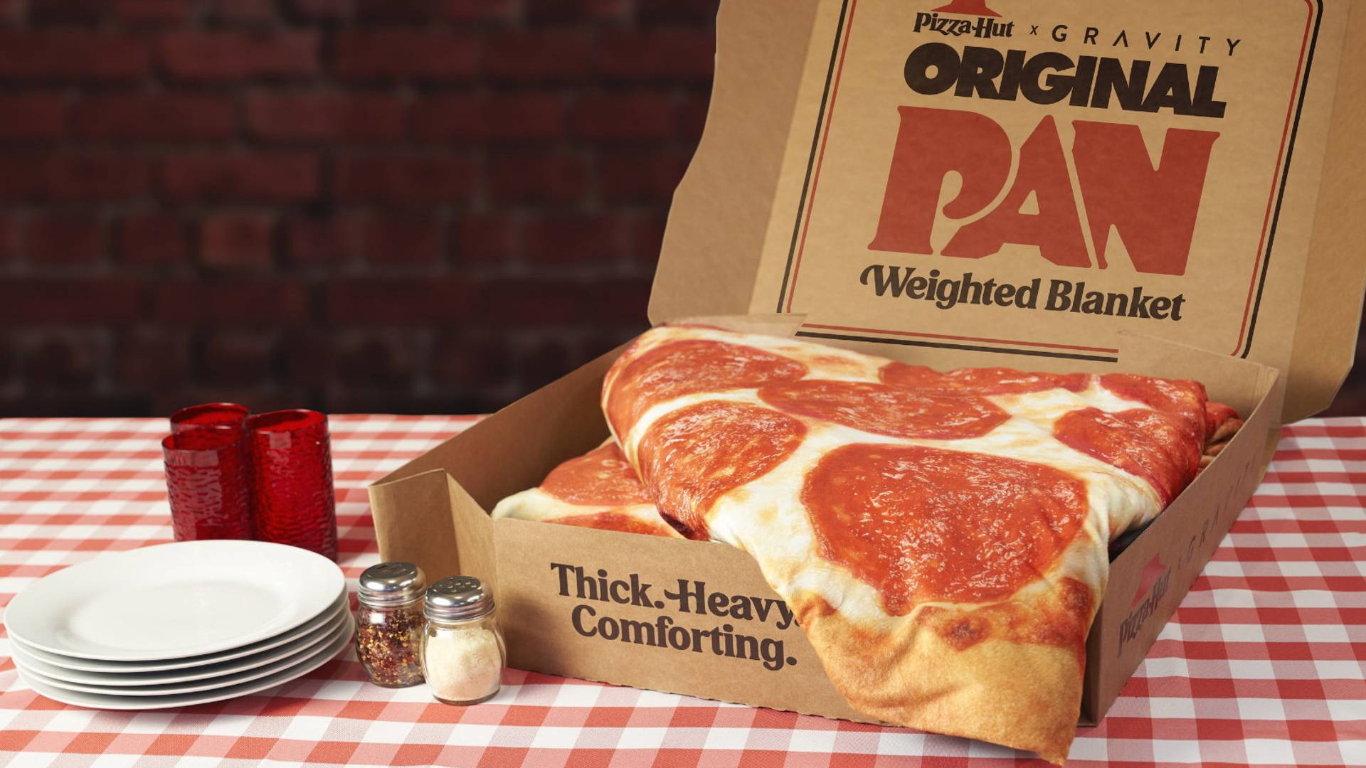 Featured image for Instead Of Eating Your Feelings, Wrap Yourself In A Weighted Pizza Hut Gravity Blanket