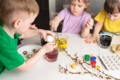 Children painting Easter eggs.