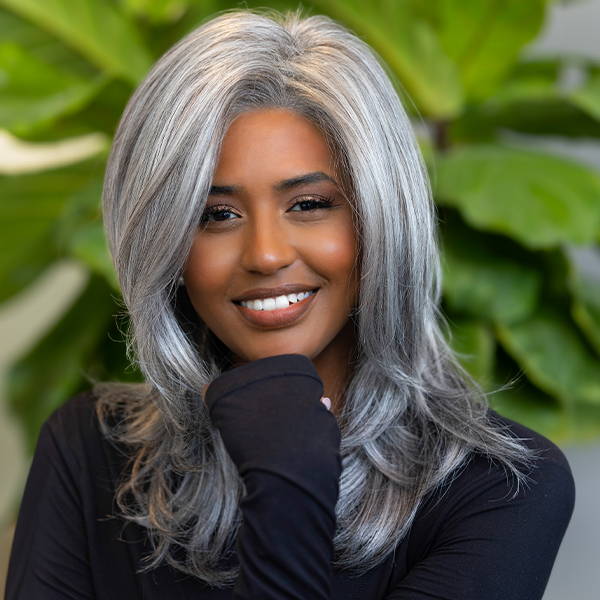 A woman with a grey colored wig in the style Jodie by Rene of Paris in shade Salt and Pepper. Is also wearing a black long sleeved top.