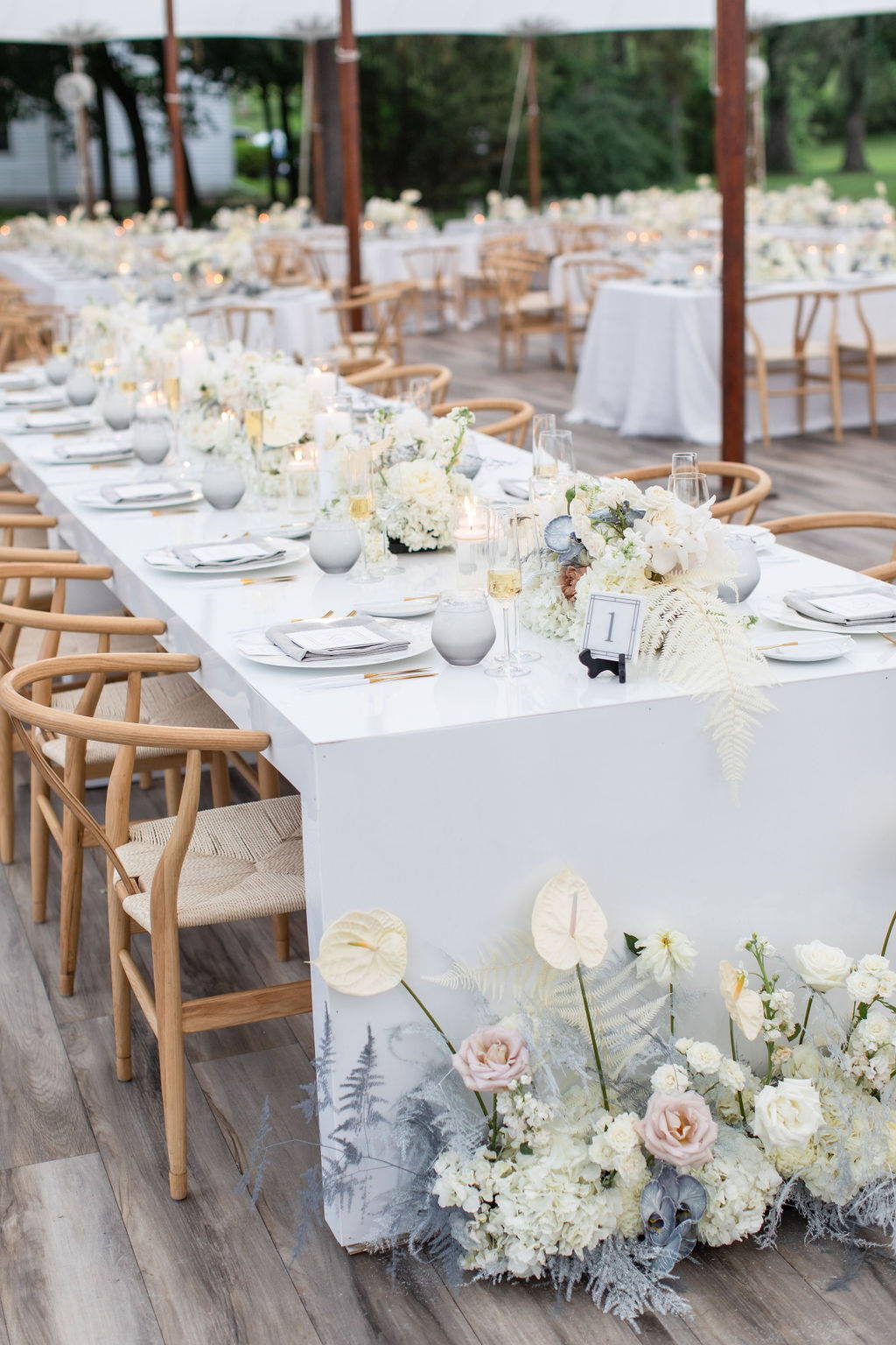 long guest table with pastel floral centerpieces down the center 