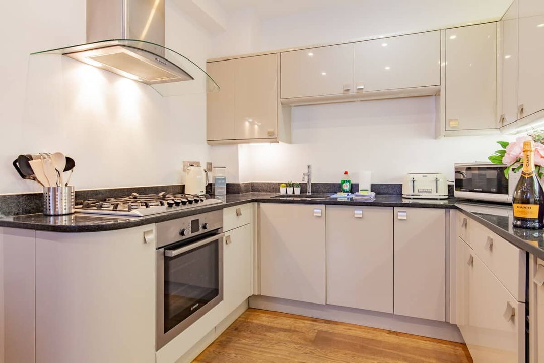 Kitchen with ample storage, white cabinets with black counter top