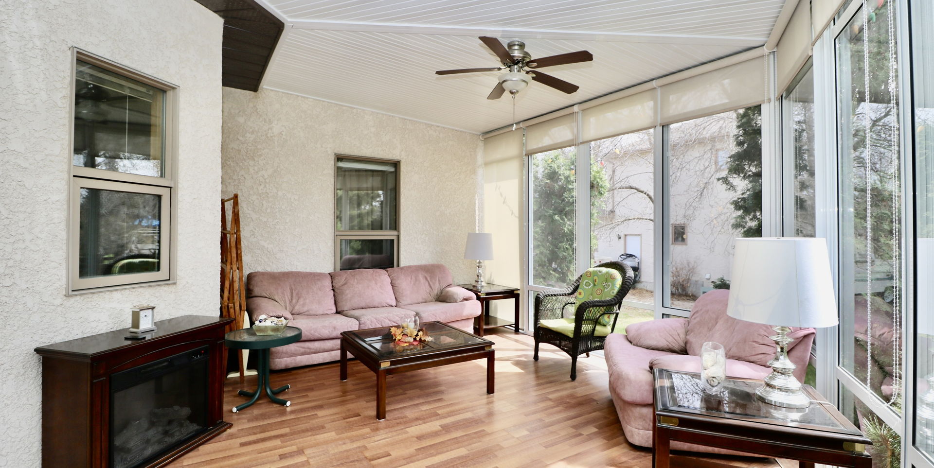 sunroom featuring hardwood flooring and a ceiling fan