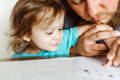 dad helping child take thumbprint