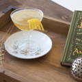 gin cocktail in coupe glass with books