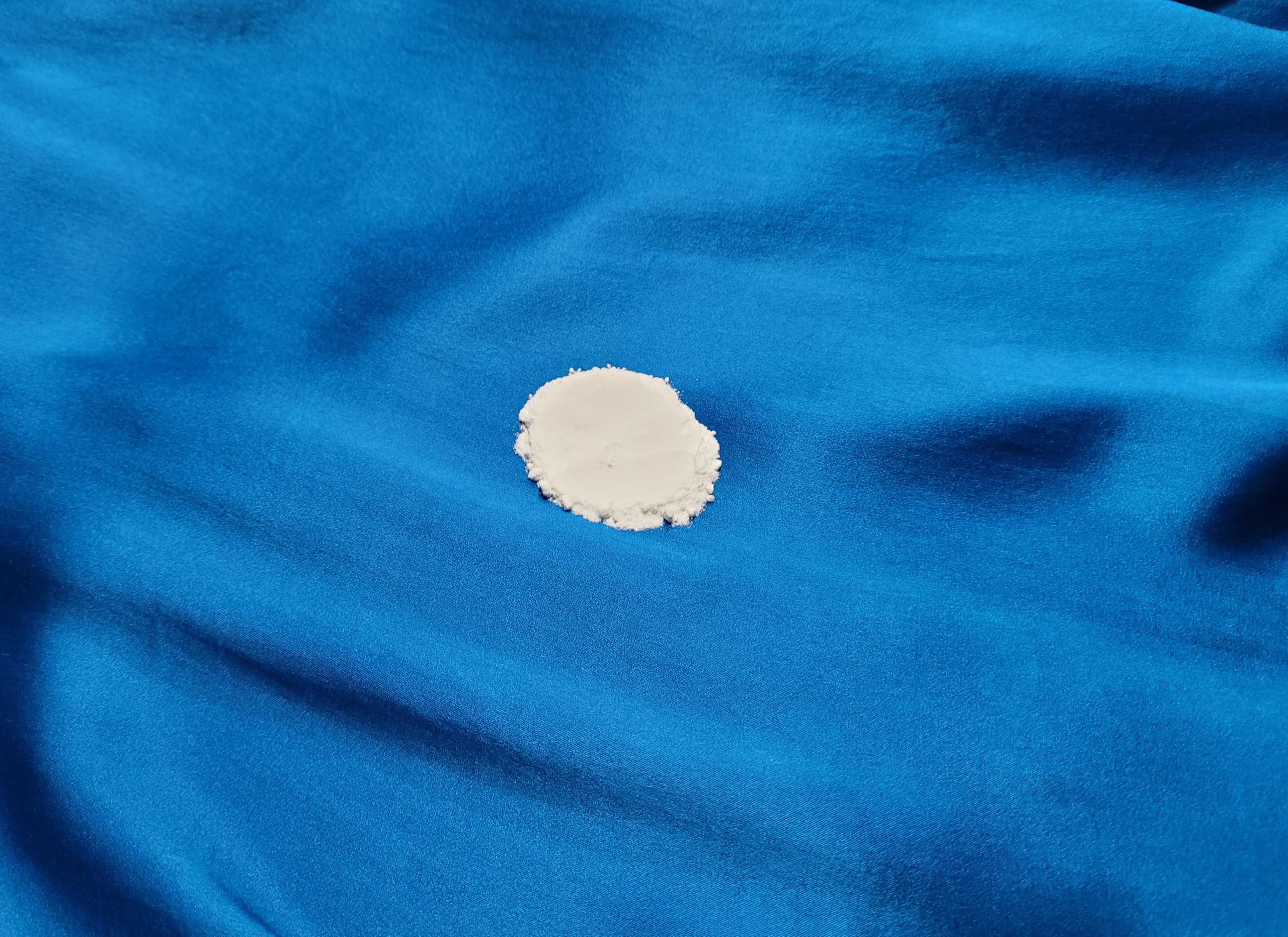 photo of baking soda being applied to a stain on silk fabric