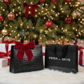 piper & skye alligator braemar tote under a christmas tree with a branded shopping piepr