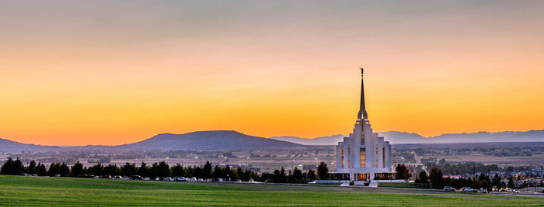 Rexburg Temple standing against a yellow sunset.