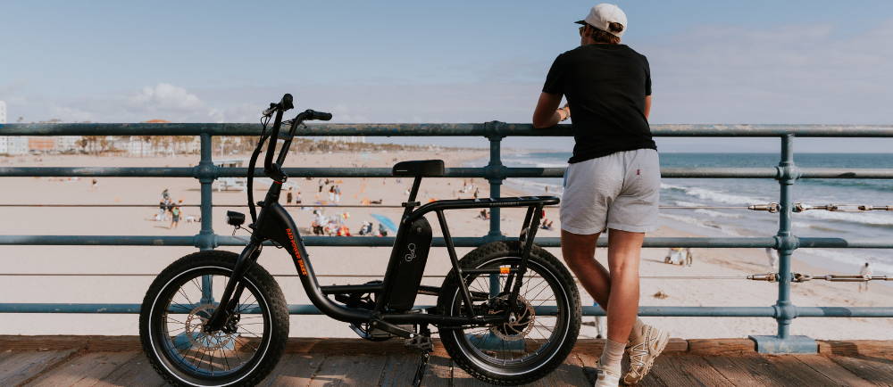 Rider on boardwalk with RadRunner 2 electric bike