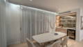 Dining Room Havit cove LED strip lighting above sheer curtains and downlights over dining table with timber joinery and bar fridge, Manly QLD