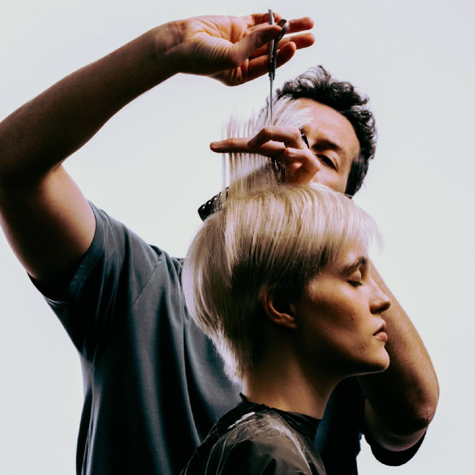 Davines hair stylist cutting a woman's hair into a pixie cut