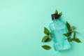 Photo of a bottle of mouthwash on a green background