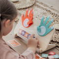 Preschooler girl learning math using the Montessori High Five Math toy.