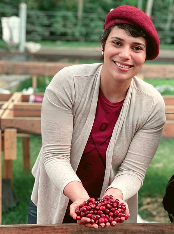 Woman holding coffee cherries