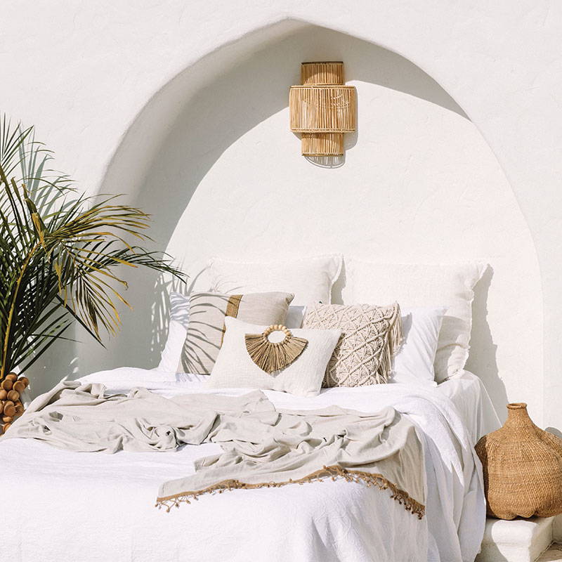 Boho cushion on a tranquil boho style bed. A perfect boho cushion to enhance your boho home decor