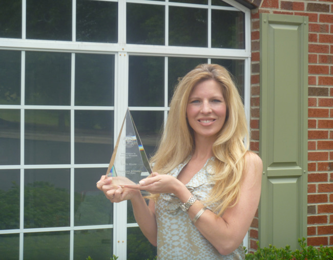 Leslie Moore stands with her National President's Award