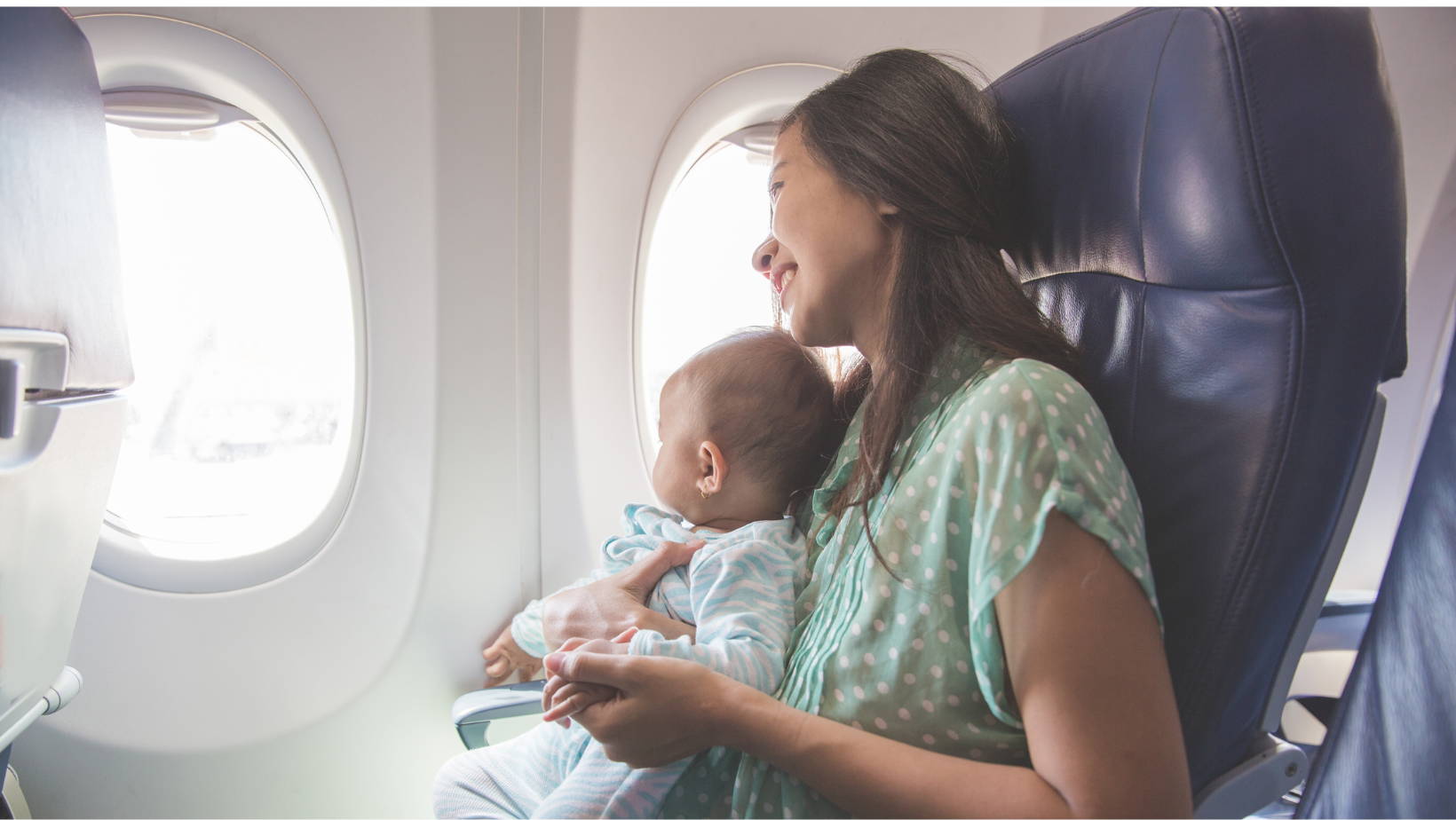 Mom holding baby in airplane | My Organic Company
