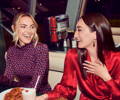 Two laughing women at a diner