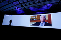 An enormous image of Chuck Schwab overlooks the assembled advisors at the McCormack Center Wednesday.