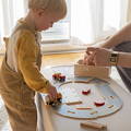 Little boy playing with wooden fuel truck and a red car featured in the Montessori Track Builder Kit toy.